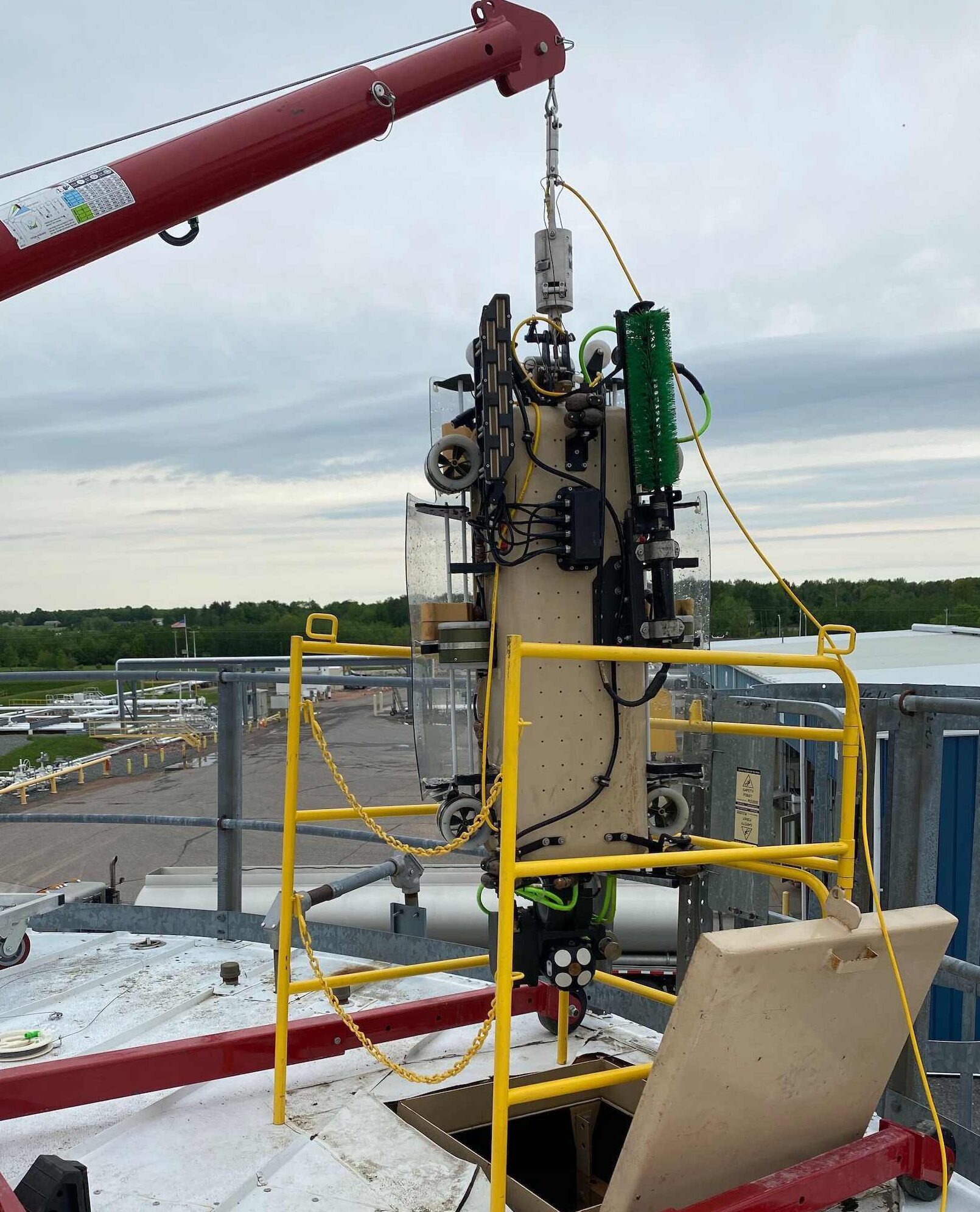 Robotic tank inspection crawler being lowered onto a storage tank roof